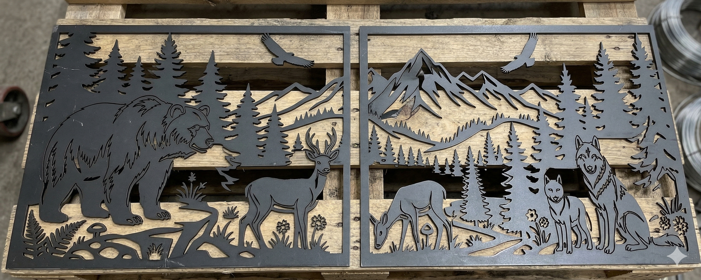Real-world photo of raw metal panels with laser-cut wildlife and mountain motifs, lying on a workshop table ready for finishing.