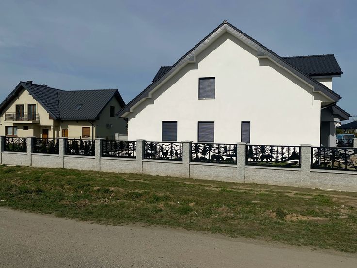 Two houses with white facades and black roof shingles on a clear day.