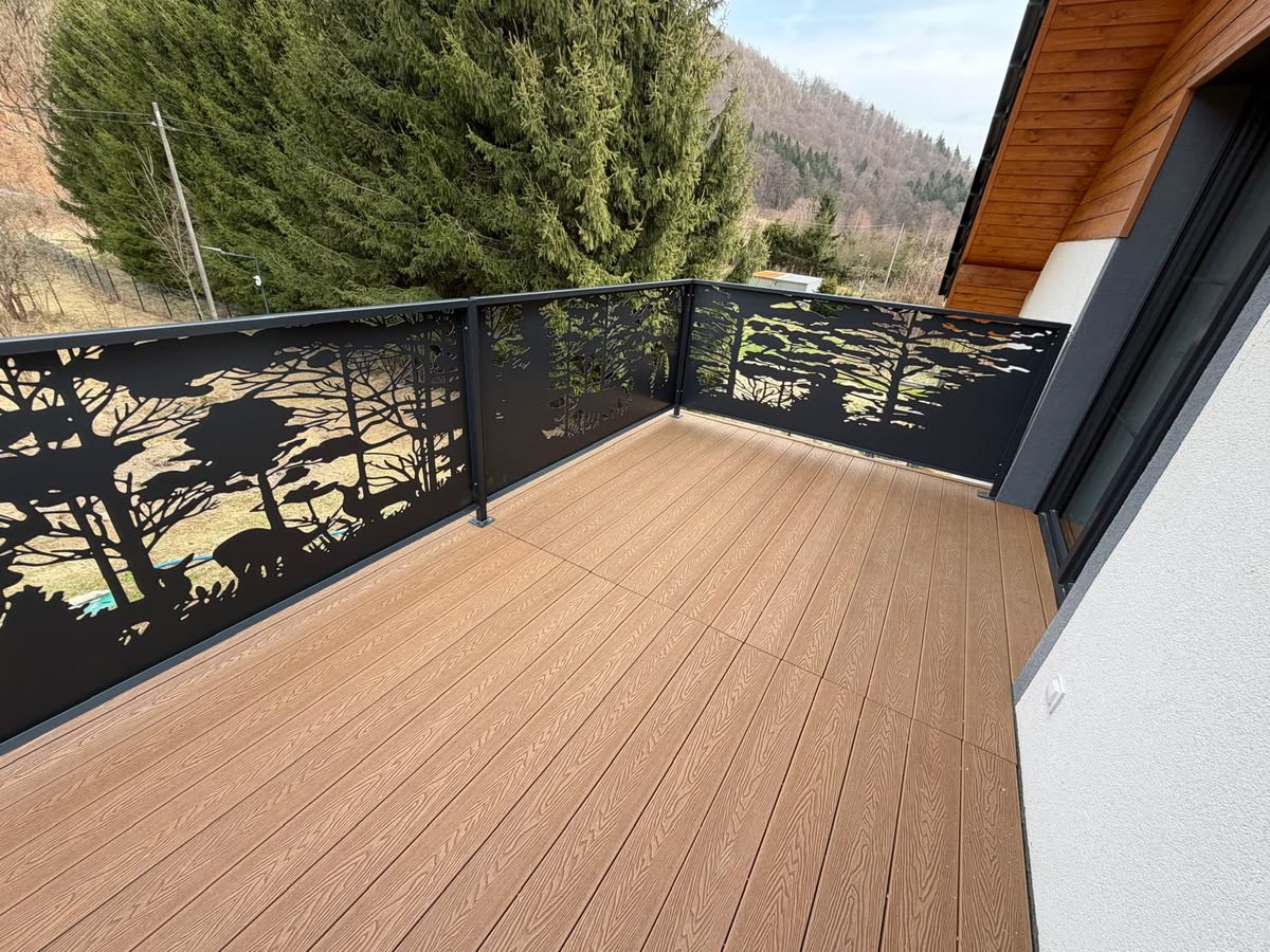 Wooden deck with metal railing overlooking a forested area