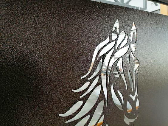 Metallic horse head design on a dark textured surface
